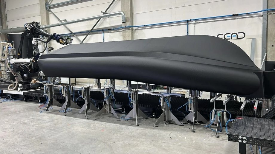 Inverted RHIB boat hull with printing robot arm