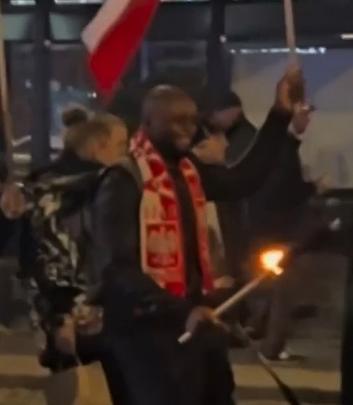 Immigrant Participates in Poland's Far-Right March, Remains Unaffected by Slogans — An immigrant at a far-right march in